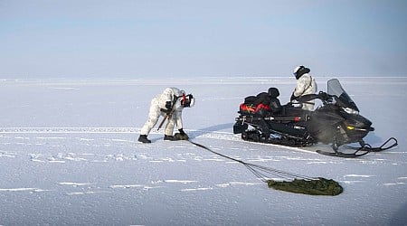 Navy SEALs on snowmobiles raced across the frozen Arctic to link up with an attack sub that broke the ice during a special ops first