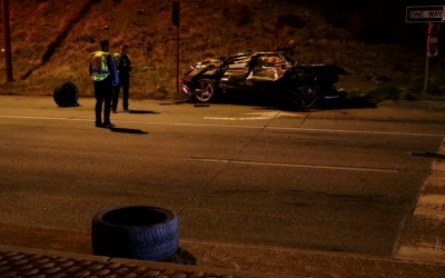 Two people hospitalized after a car drove off of I-25 and landed on Nevada Ave.