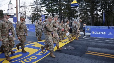 Military marchers set out from Hopkinton to start the 128th Boston Marathon