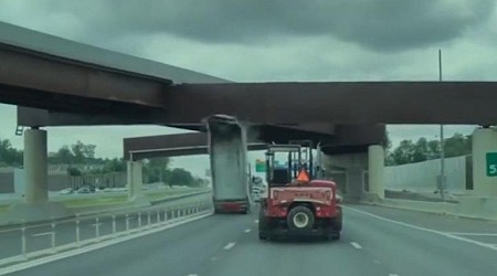 Dump truck's raised trailer hits overpass bridge in Virginia