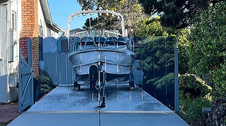 A man ordered to hide his boat painted his new fence with the offending boat. The act of rebellion is changing his city.