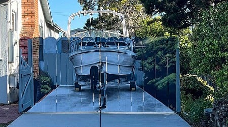 A man ordered to hide his boat painted his new fence with the offending boat. The act of rebellion is changing his city.