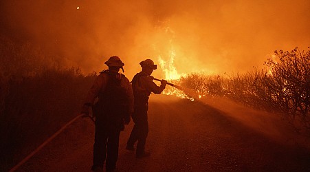 A fast-moving wildfire spreads north of Los Angeles, forcing evacuations