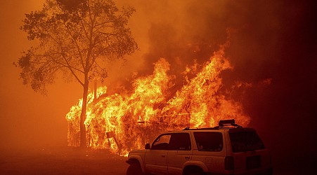 Lightning and a burning car pushed into a gully are blamed for wildfires in the West