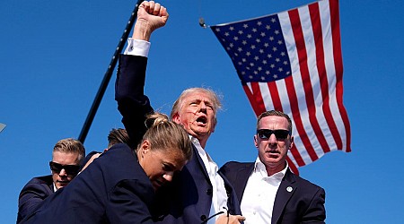 Photos show Trump, blood on his face, pumping his fist after an incident at his rally