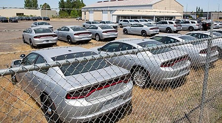 A fenced lot in Salem has dozens of silver Chargers and Durangos. Why is that?