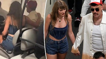 Taylor Swift cuddles up to Travis Kelce as they dash out of stadium following Chiefs win