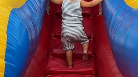 WATCH: Sister cheers on little brother, shows him how to go down slide