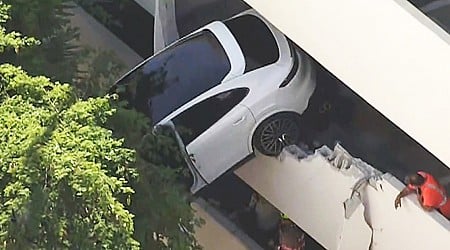 Woman rescued after crash leaves Porsche dangling from Florida parking garage