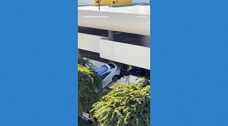 WATCH: Driver rescued from car dangling out of parking garage