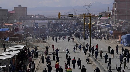 Rival protesters clash in Bolivia as ex-President Evo Morales leads a march to the capital