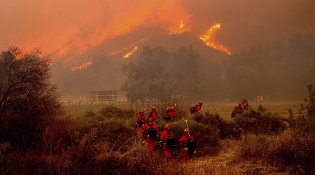 Firefighters battle to contain dangerous wildfires burning on both coasts