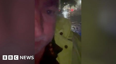 Rising flash floods leave sheriff stranded on top of car