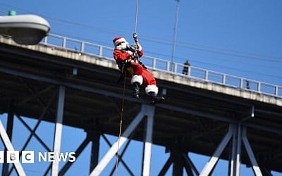 Watch: Abseiling Santa descends from Guatemala bridge to deliver toys