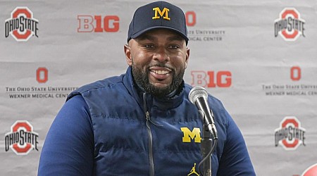 WATCH: Michigan's Sherrone Moore jabs Ohio State again by planting imaginary flag during basketball game