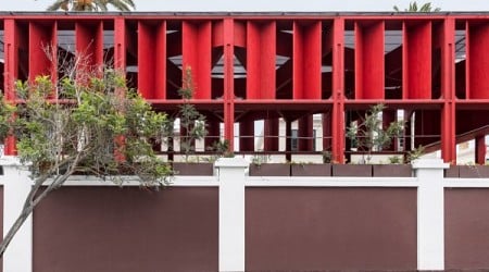 K+M Arquitectura y Urbanismo slots red pergola behind historic building in Peru