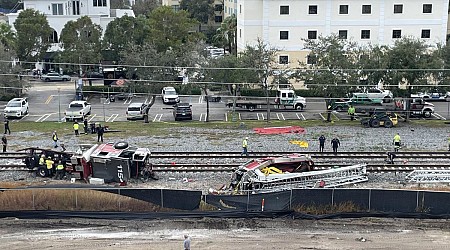 Train collides with fire truck in Florida. Police say 3 firefighters and several passengers hurt