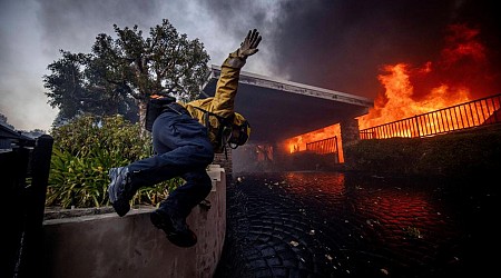 Thousands flee as wildfires burn out of control in and around Los Angeles and homes are destroyed