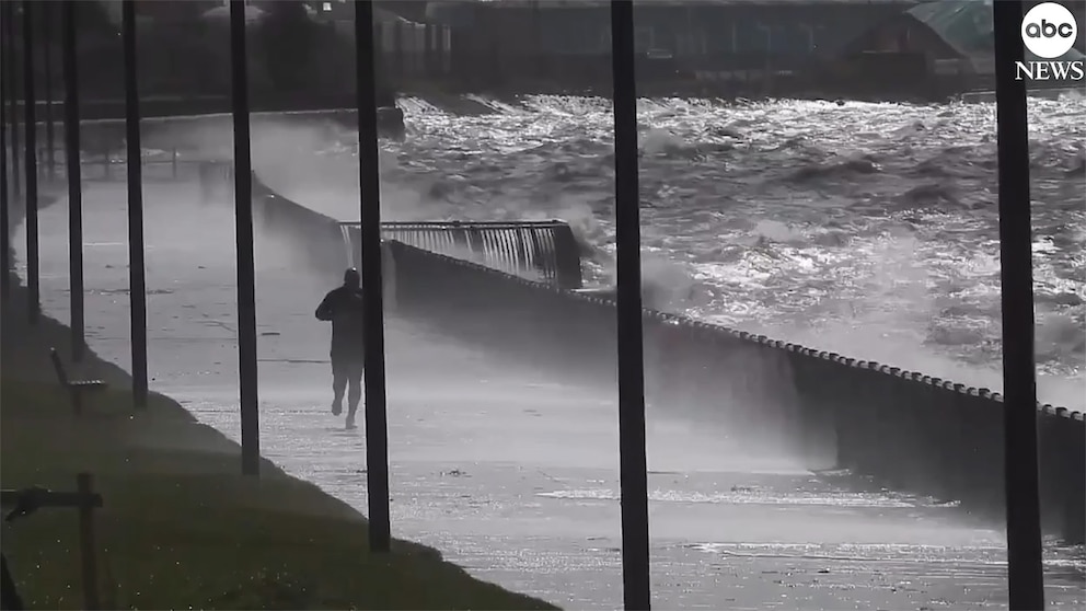 WATCH: Man calmly jogs along oceanfront as storm rages