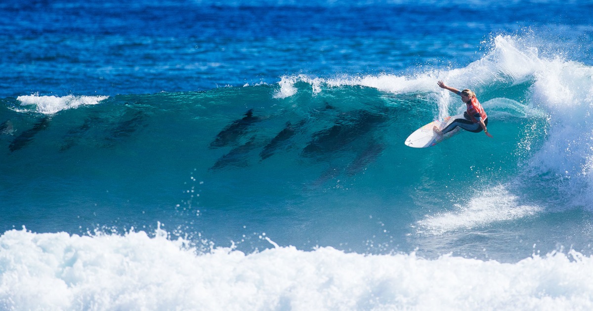 U.S. surfer accompanied by dolphins as she wins world championship event in Australia