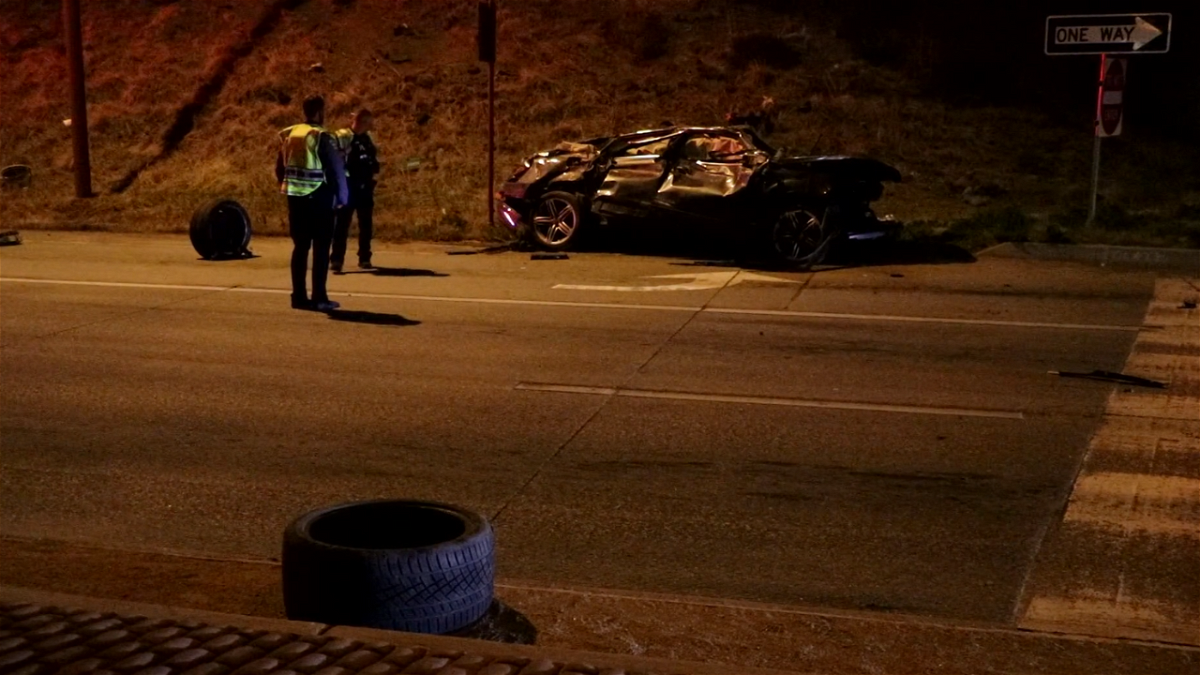 Two people hospitalized after a car drove off of I-25 and landed on Nevada Ave.