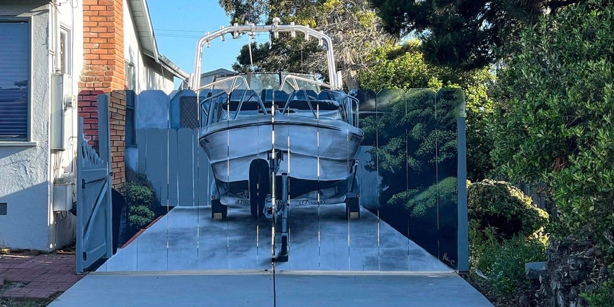 A man ordered to hide his boat painted his new fence with the offending boat. The act of rebellion is changing his city.