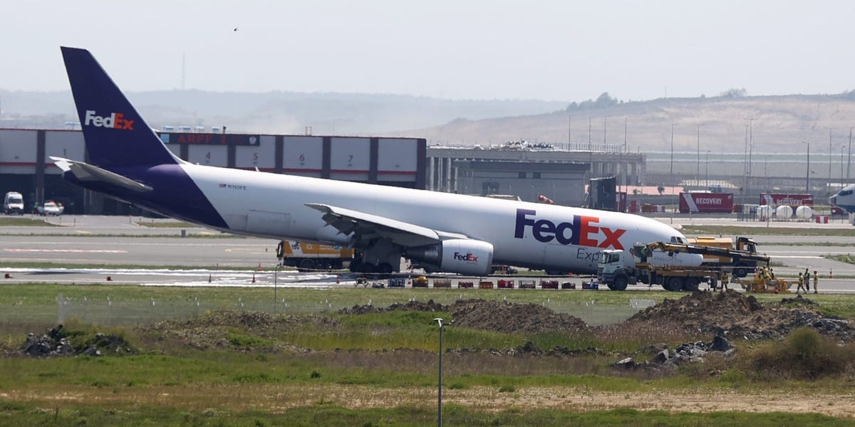 Video shows the scary moment a Boeing cargo plane skidded and threw up sparks when its landing gear failed to deploy properly