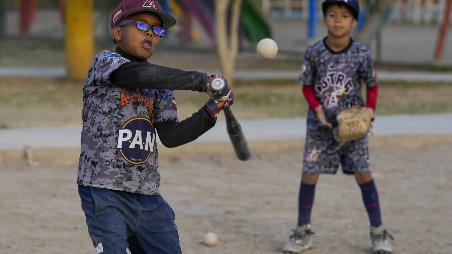 Baseball becomes a shelter for Venezuelan children in soccer-mad Peru