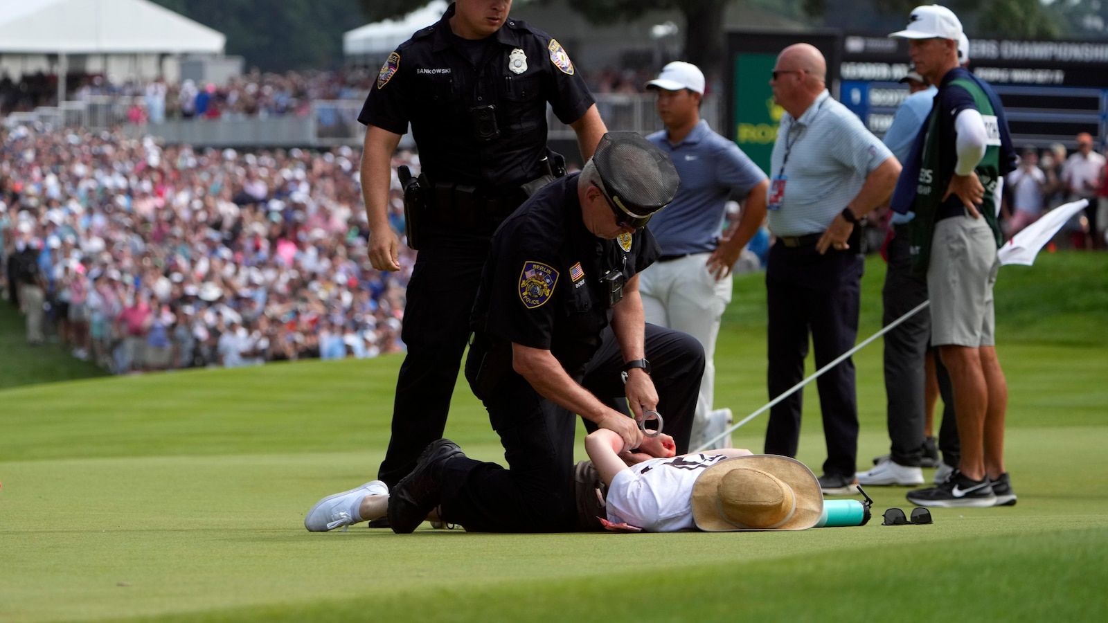 Six climate protesters run onto 18th green and spray powder, delaying finish of PGA Tour event