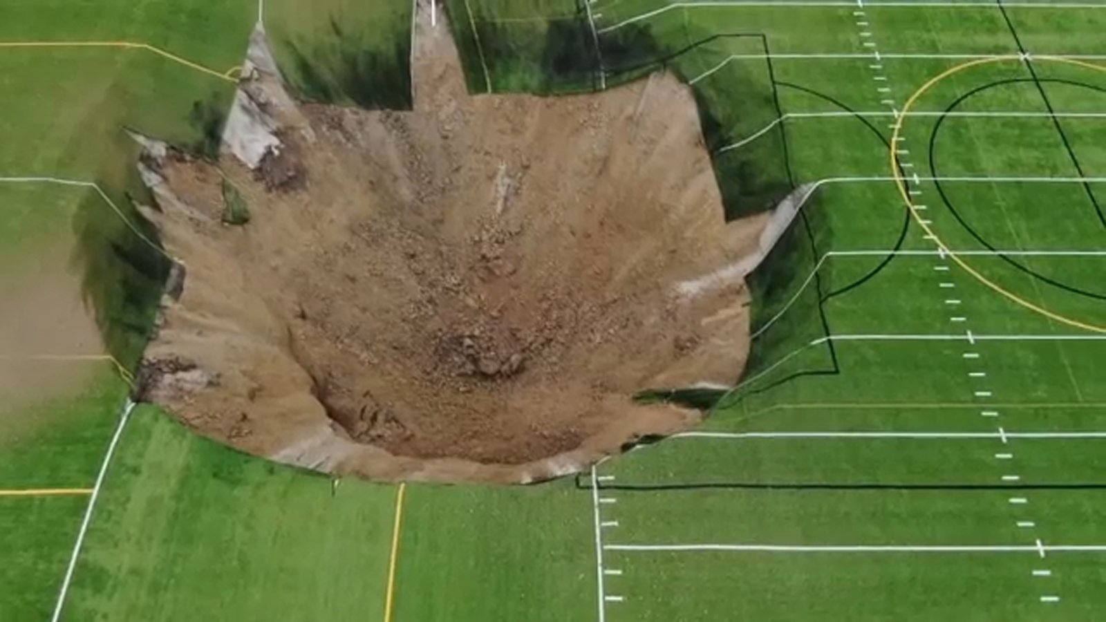 Video shows 100-foot-wide sinkhole open up under soccer field in Illinois