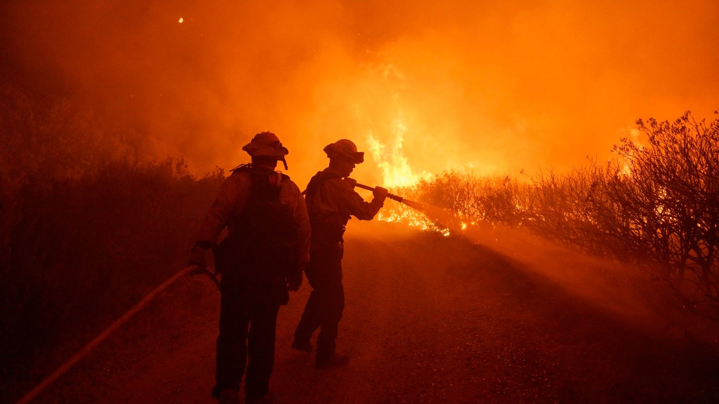 A fast-moving wildfire spreads north of Los Angeles, forcing evacuations