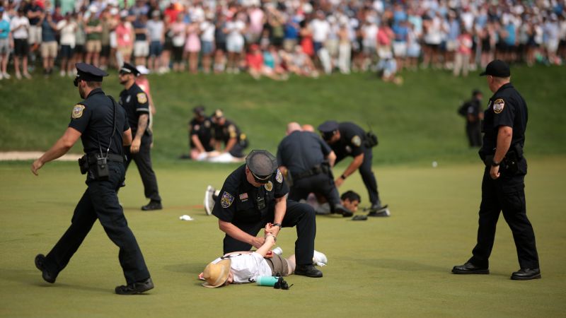 Climate protesters disrupt play at 18th hole of PGA Tour’s Travelers Championship