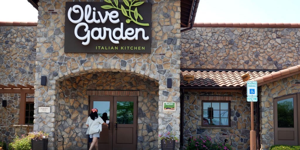 Olive Garden's parent company says it's luring diners in by not raising prices as much as rivals — even if it's not offering hefty discounts
