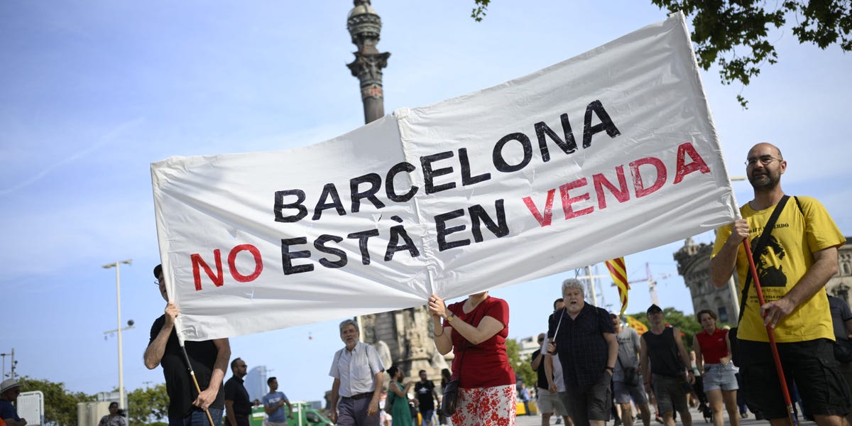 Protesters spray water guns at tourists in Barcelona as thousands rally against overtourism