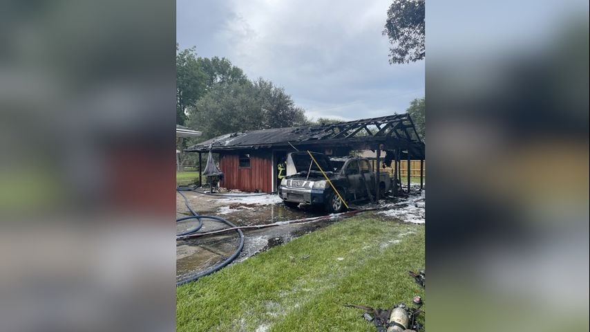 Garage set on fire, considered total loss due to resident improperly dumping coals after grilling