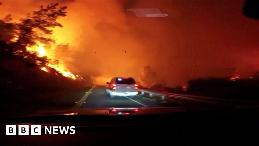 Vehicle drives through intense wildfire in California