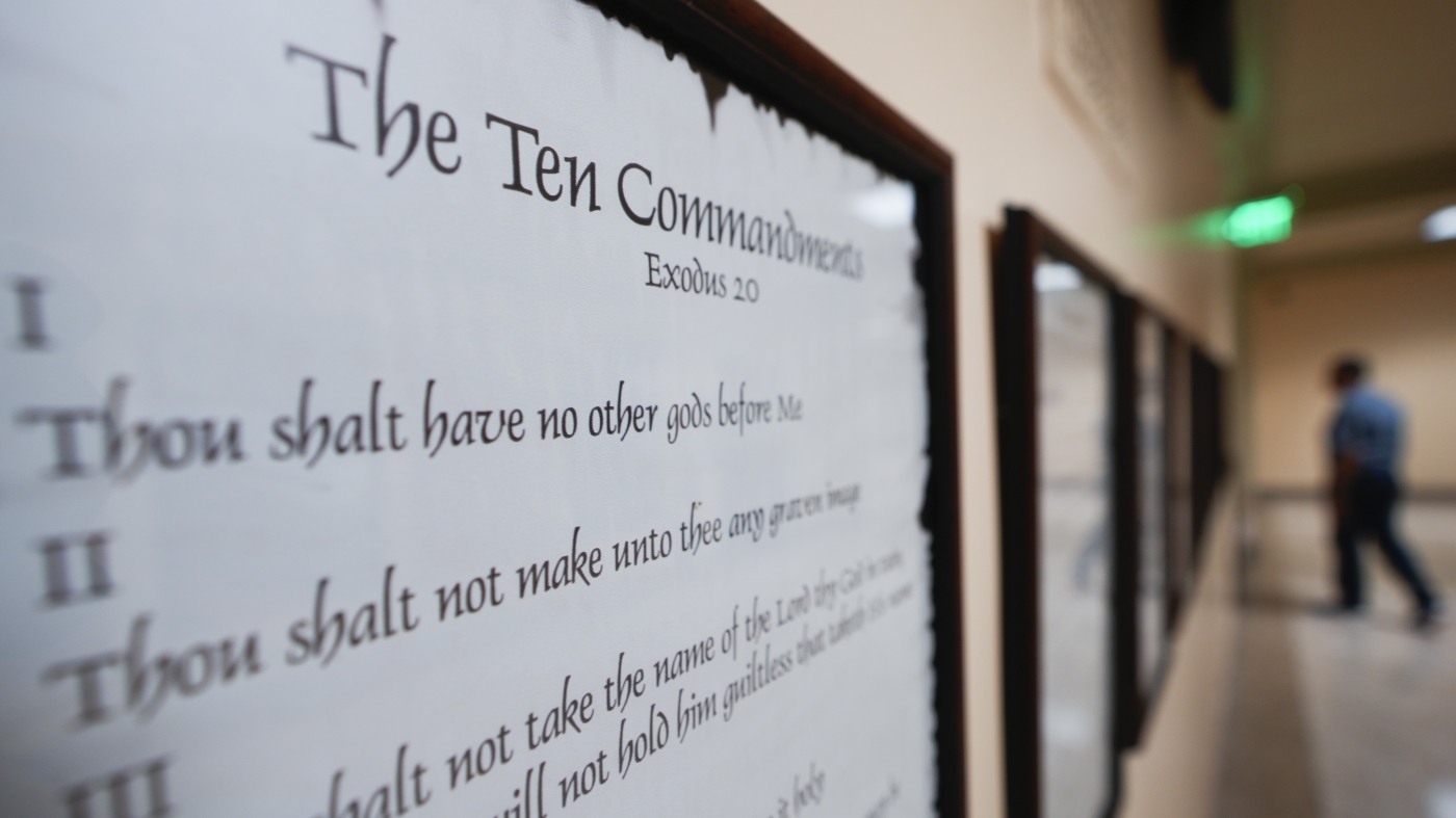 How will Louisiana's Ten Commandments classroom requirement be funded and enforced?