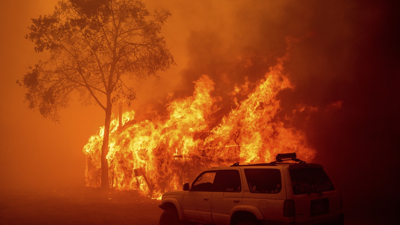 Lightning and a burning car pushed into a gully are blamed for wildfires in the West