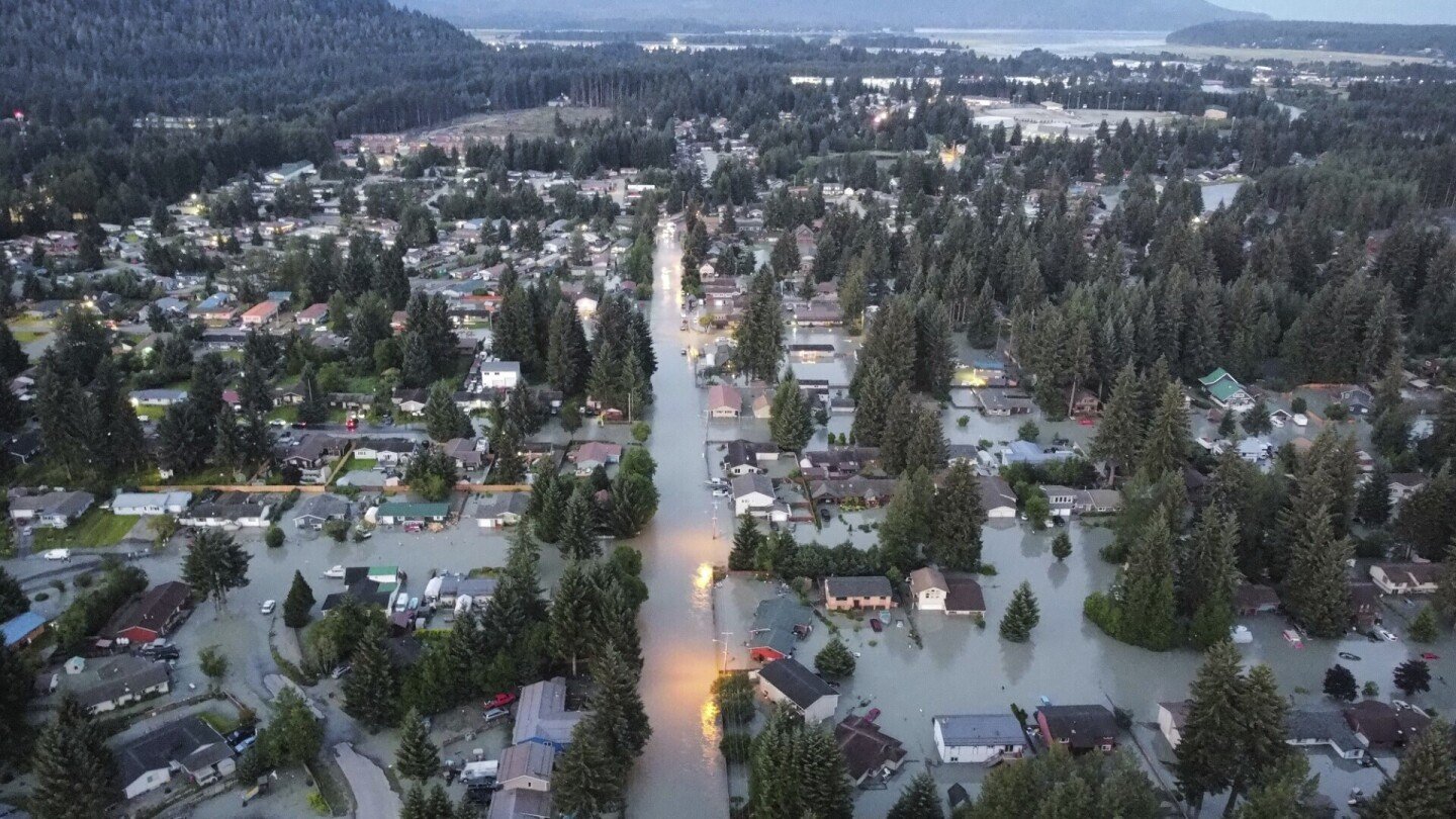 Picturesque glacier releases water down a river in Alaska. More than 100 homes are damaged