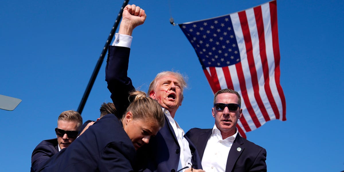 Donald Trump is escorted from stage after pops heard during Pennsylvania rally