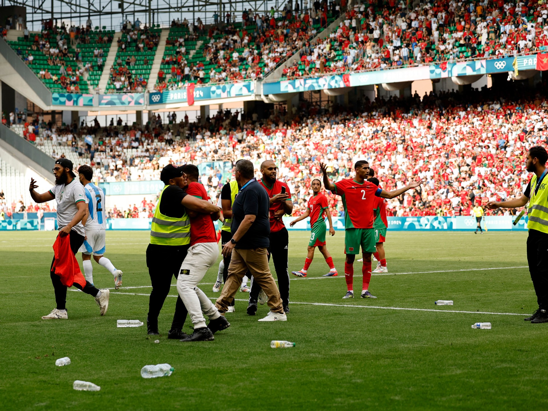 Paris Olympics organisers investigating football pitch invasion mayhem