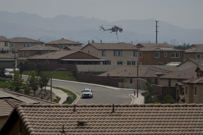 Wildfires east of LA and south of Reno threaten homes and force thousands to evacuate