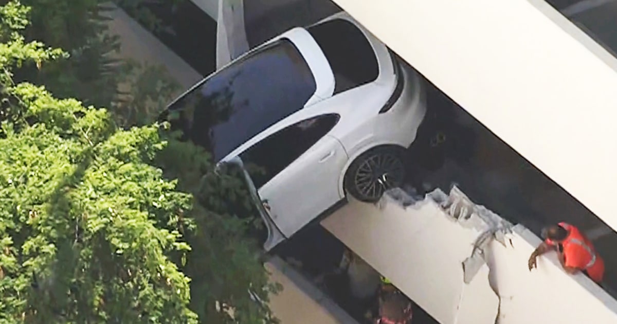 Woman rescued after crash leaves Porsche dangling from Florida parking garage