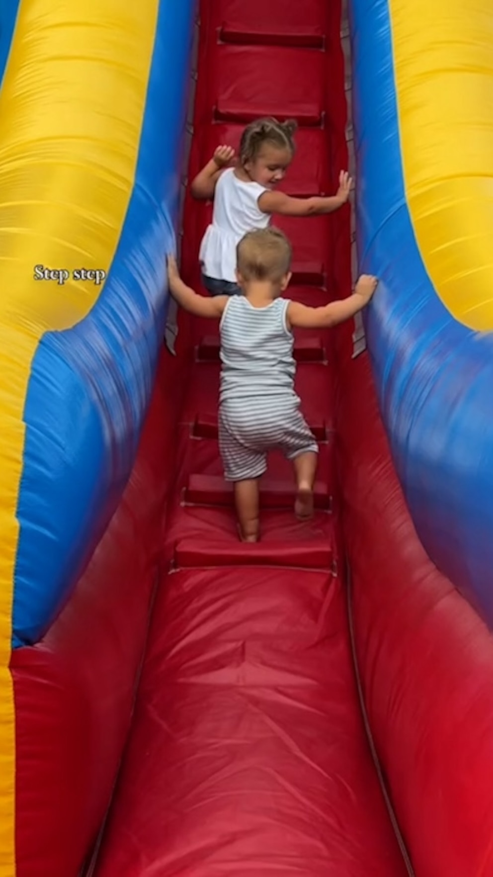 WATCH: Sister cheers on little brother, shows him how to go down slide