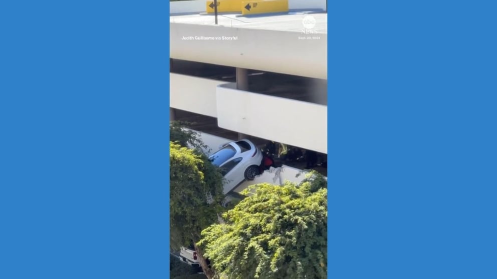 WATCH: Driver rescued from car dangling out of parking garage