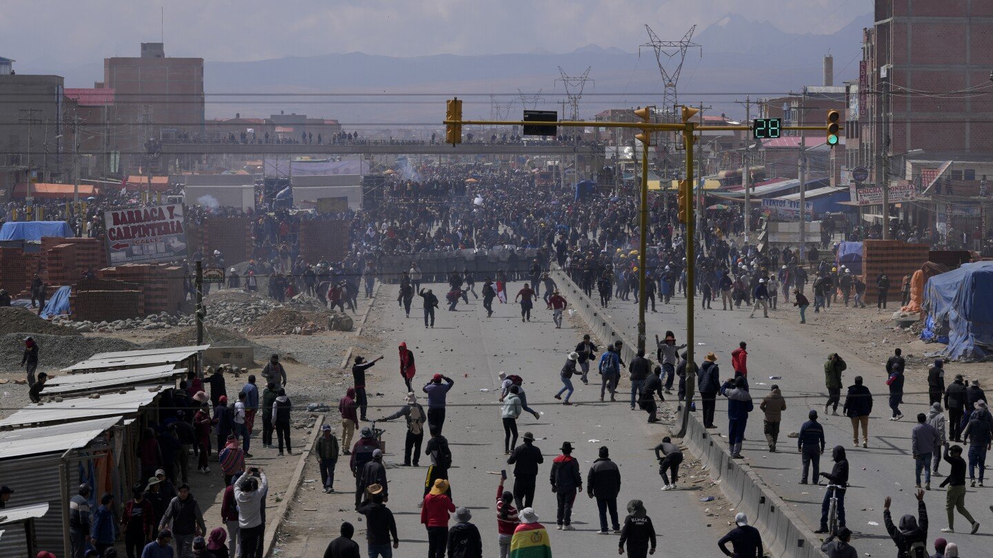 Rival protesters clash in Bolivia as ex-President Evo Morales leads a march to the capital