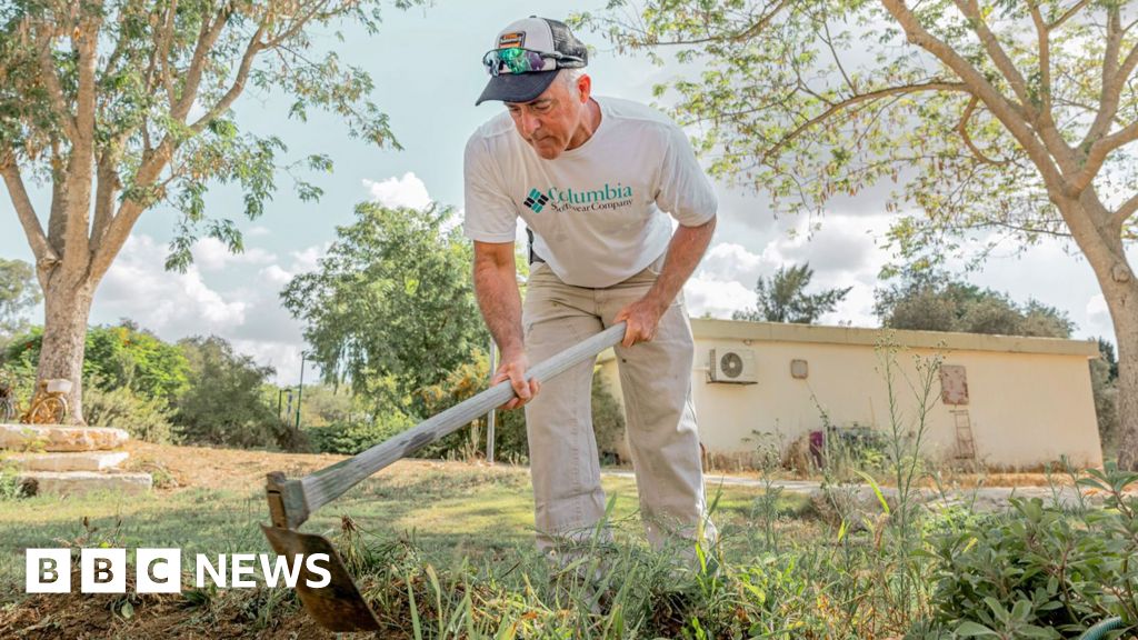 Keeping lawns neat in front of burned homes - a year on at kibbutz where Hamas killed 101