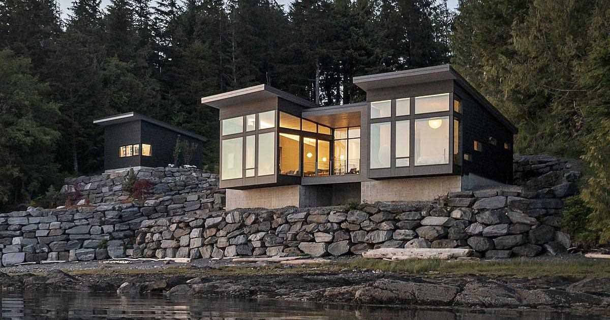 A New Home Overhanging The Water's Edge In Alaska