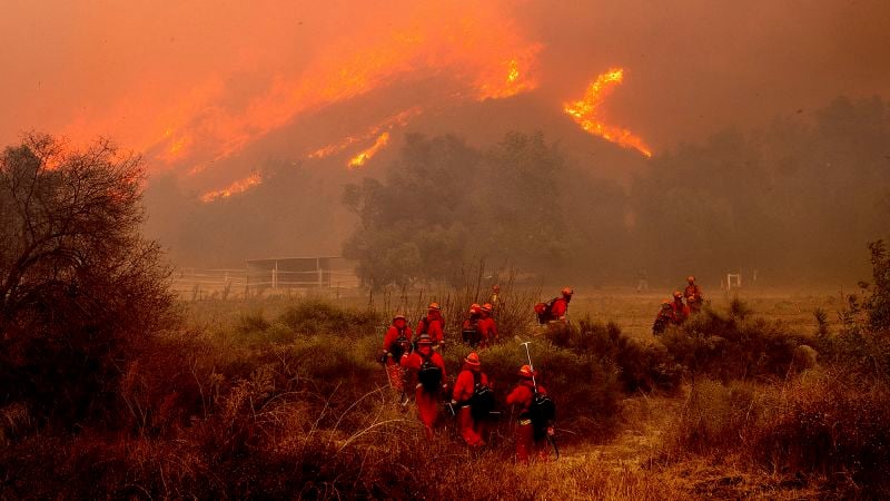 Firefighters battle to contain dangerous wildfires burning on both coasts