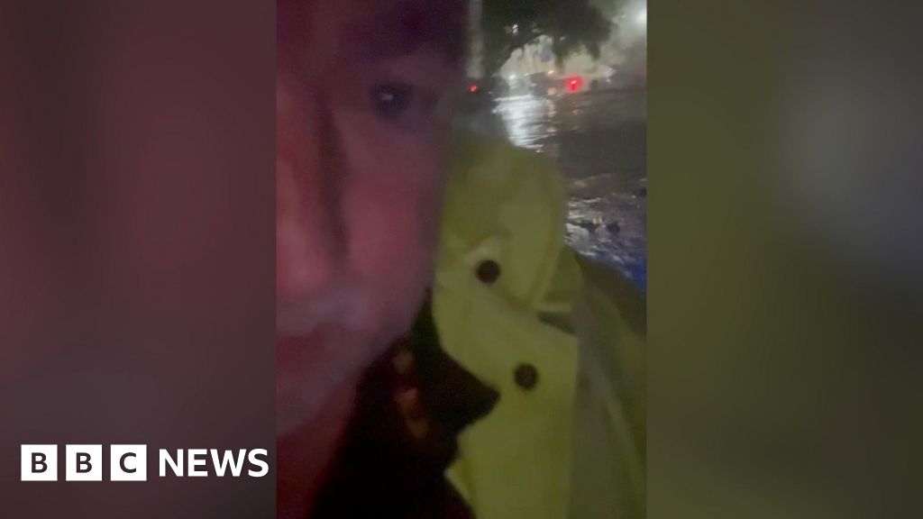 Rising flash floods leave sheriff stranded on top of car